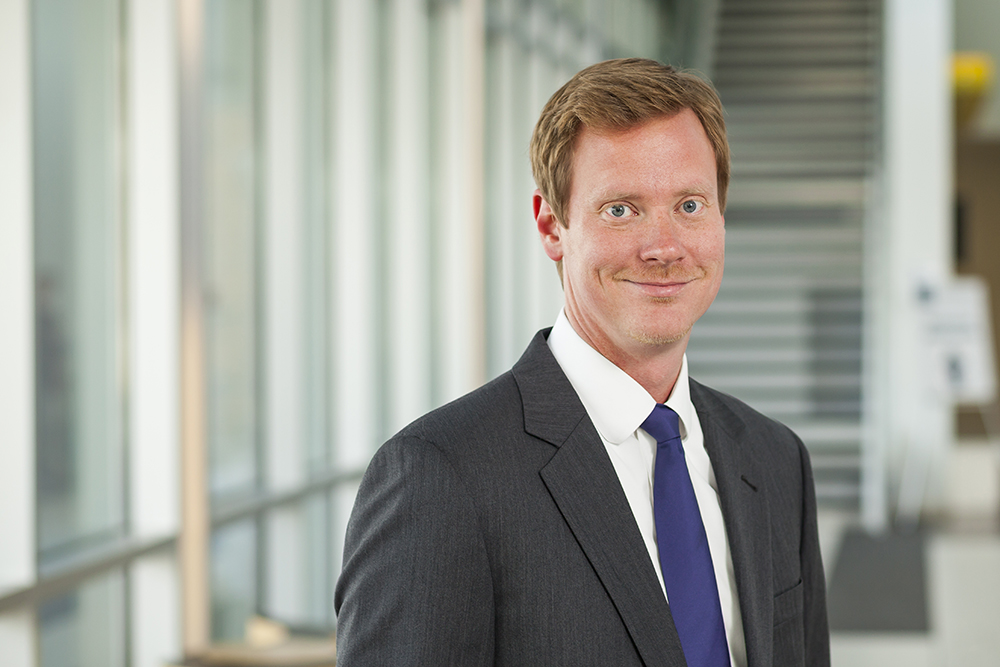 Chris Copp, Owner and Principal Evaluator, wearing a dark suit and blue tie